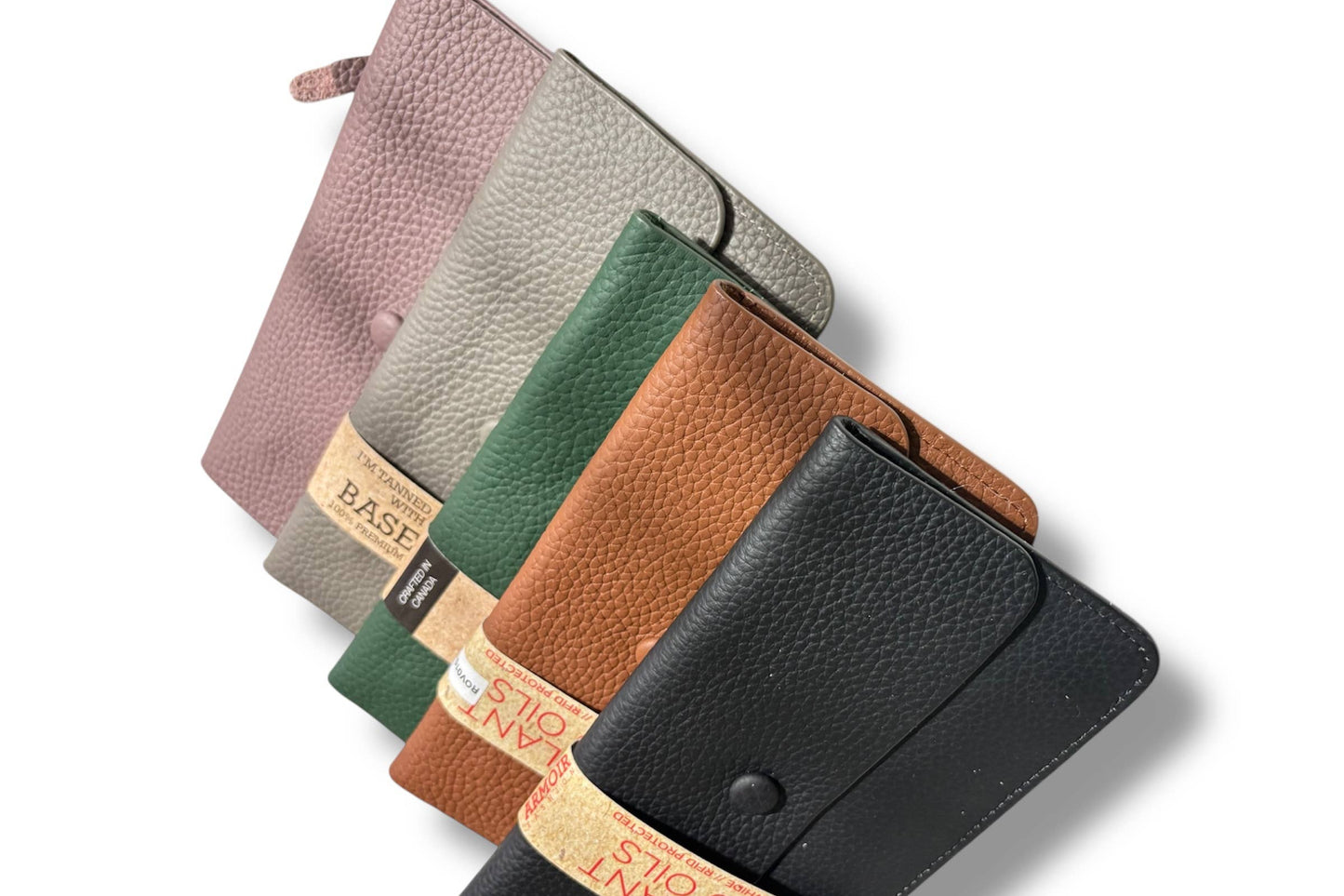Four textured leather wallets from Armoir are arranged diagonally on a white background. 