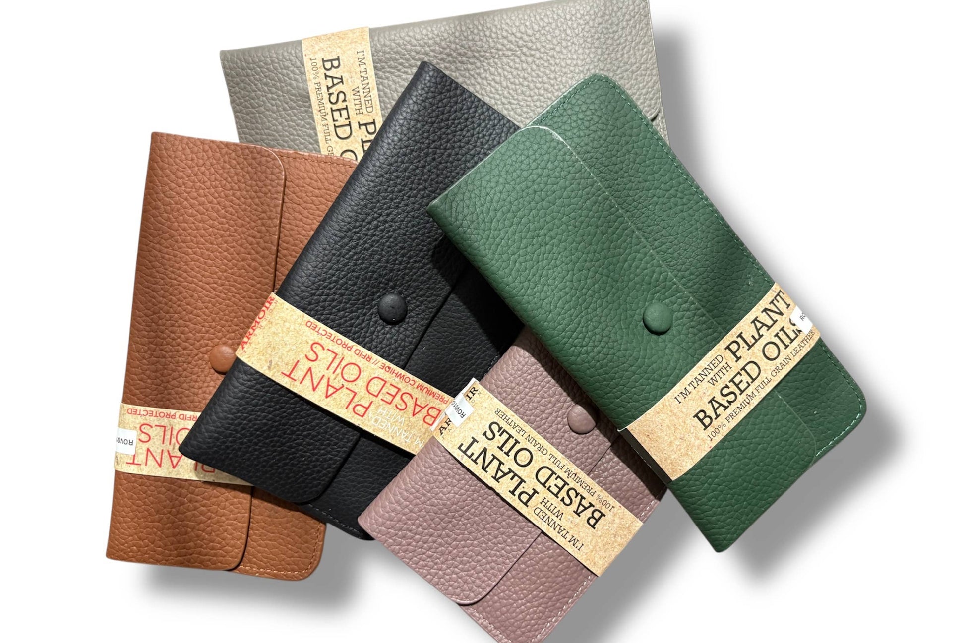 Four textured leather wallets from Armoir are arranged diagonally on a white background. 