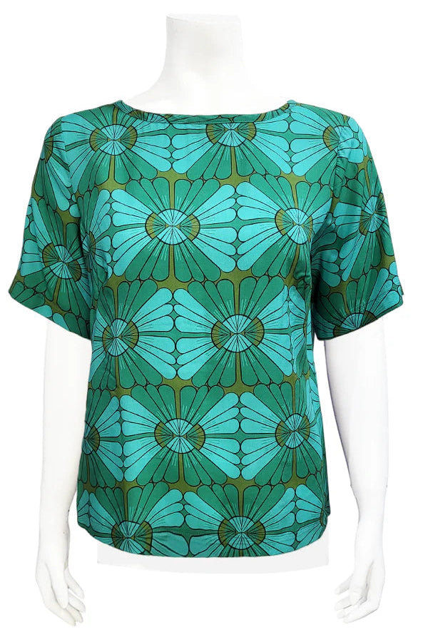 The Cecil Box Blouse by Mandala in Vintage Tile print is shown on a mannequin against a white background. It has a high neckline, wide 1/2 sleeves, and a side hem slit detail. 
