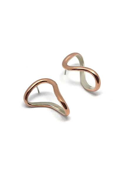 Pair of silver lined copper earrings on a white background