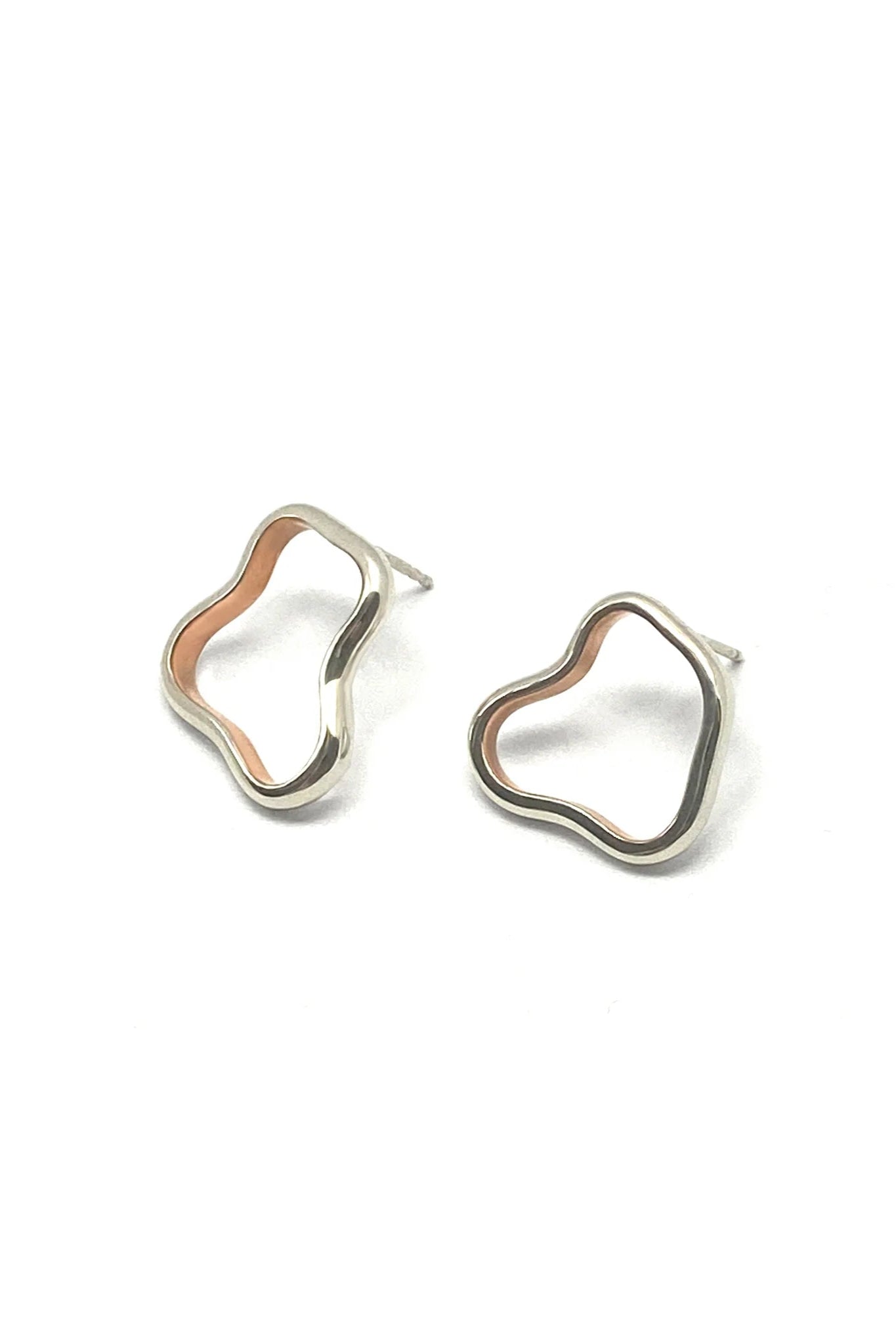 Pair of copper lined silver hoop earrings on a white background