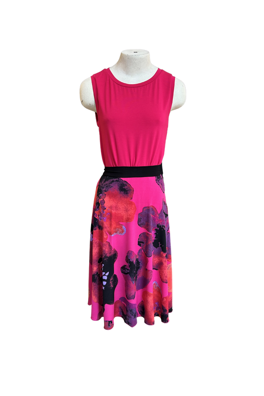 The Folie Skirt in Fuchsia Print by Slak is shown on a mannequin with the Neon Camisole in Fuchsia against a white background. It's a below-the-knee A-line skirt with a contrast pull-on waistband. 