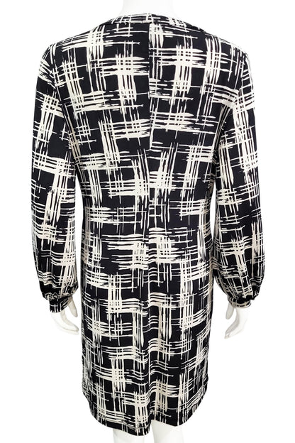 A back view of the Gwyneth mini dress from Mandala in Hopscotch - Black is shown on a mannequin against a white background 