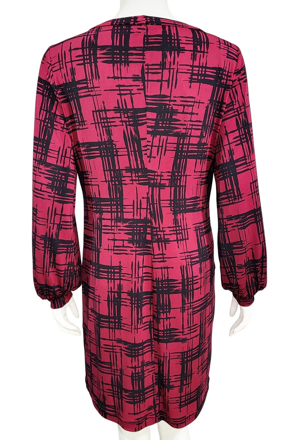 A back view of the Gwyneth mini dress from Mandala in Hopscotch - Cherry is shown on a mannequin against a white background 