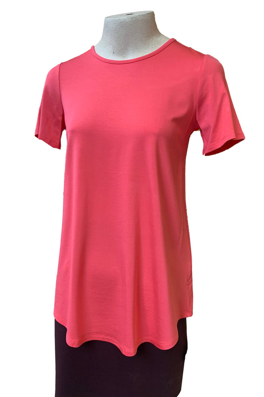The Catherine Tee by Pure Essence in Coral is shown on a mannequin against a white background 