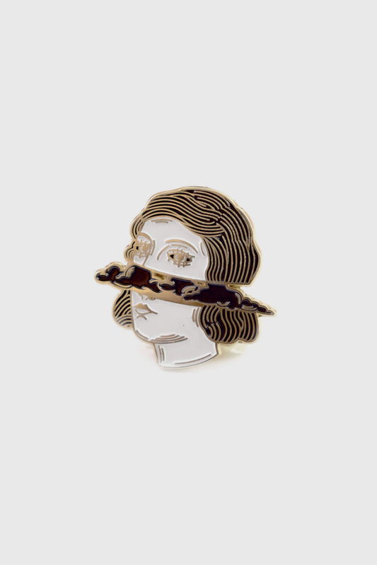 The Cloud Head pin from Badaboöm Studio, depicting a women's face horizontally bisected by dark clouds, is shown against a white background. 