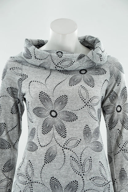 A close up of the Teddy Pearl Sweater by Karkass in Grey and Black, a cowl neck sweater with a floral pattern in black dots, is shown on a mannequin with jeans against a white background. 