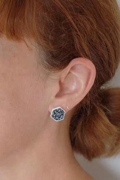 Person wearing a black and white Lilipop DND dice earring. 