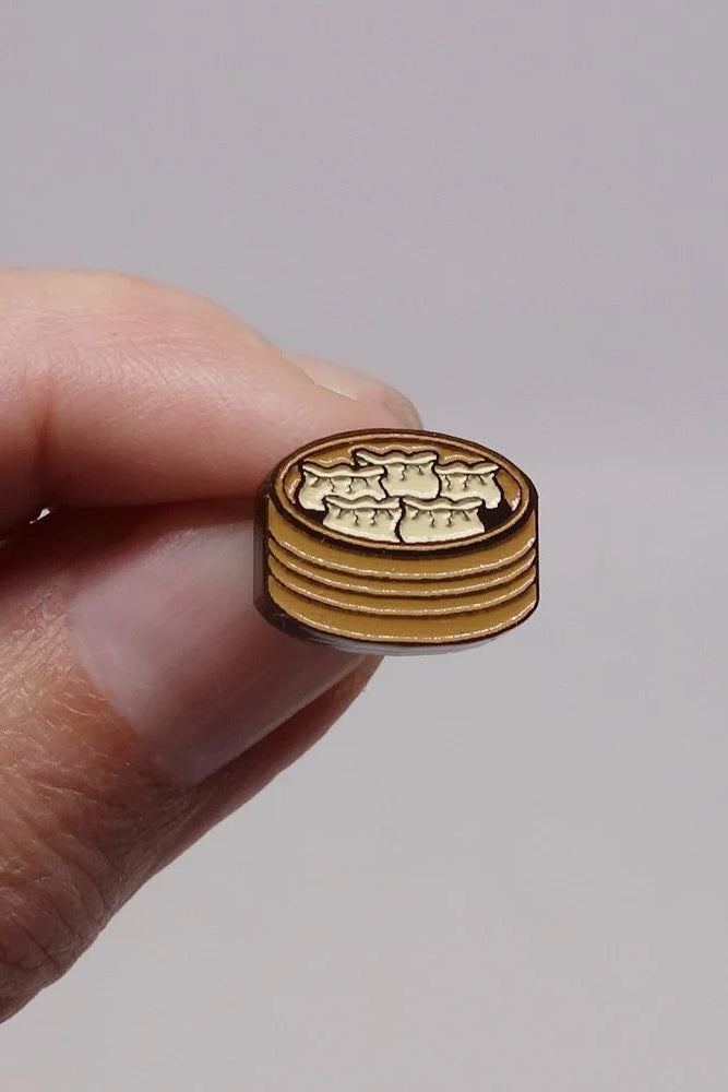 Person's hand holding a Dumpling Earring by Lilipop 