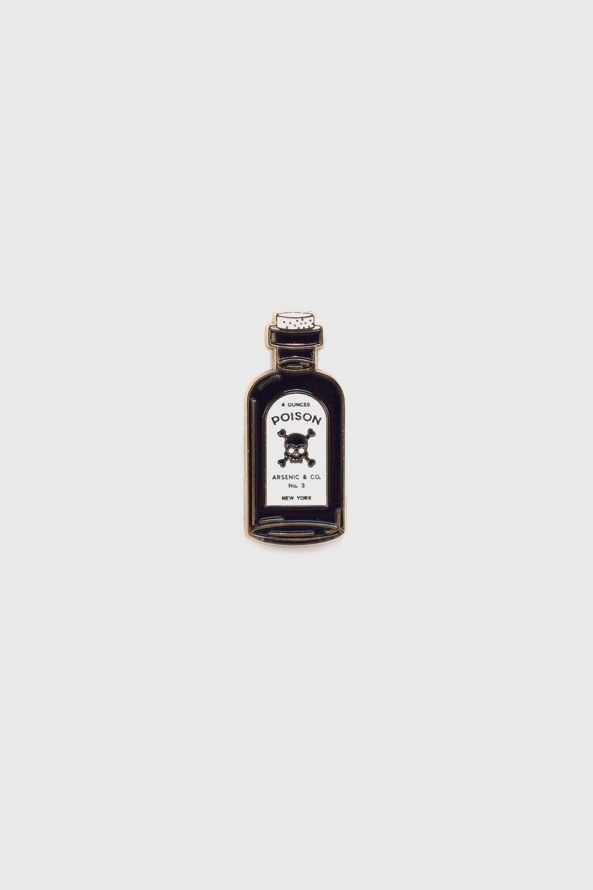 The Poison Pin by Badaboöm Studio, featuring a tiny bottle of poison, is shown against a white background. 