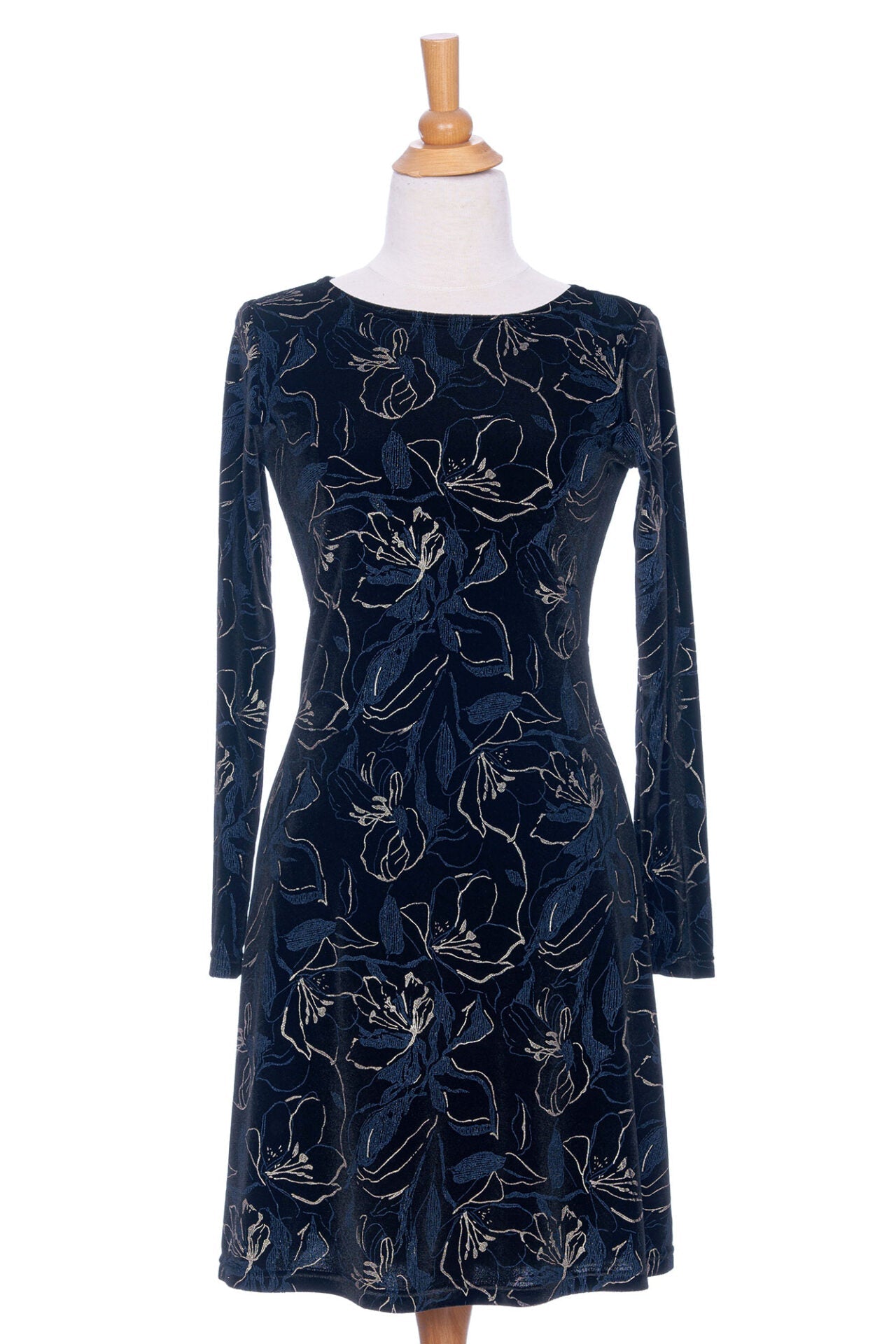 The Larix Dress by Rien ne se Perd in Black/Navy/Gold, a velvet dress with a floral pattern, a round neck, an a knee-length A-line shape, is shown on a mannequin in front of a white background. 